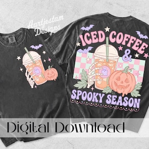 May include: A black t-shirt featuring a graphic of a skeleton hand holding an iced coffee cup with a ghost sticker, a pumpkin, and bats. The back design includes the text ICED COFFEE & SPOOKY SEASON in pink and purple over a checkered background.