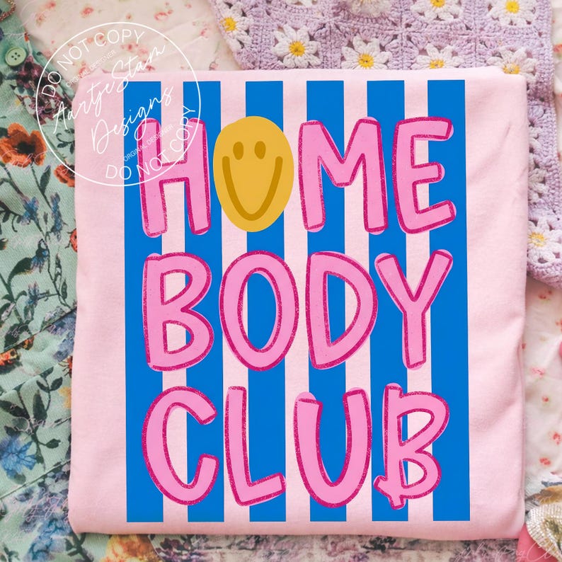 Homebody Club shirt PNG retro Y2K bubble letter smiley face blue stripe hot pink text, on pink tee flatlay, coquette aesthetic soft girl sassy little girl mommy and me matching funny saying shirt lazy girl era, for DTF transfers, sublimation shirts, tumblers, apparel printing.