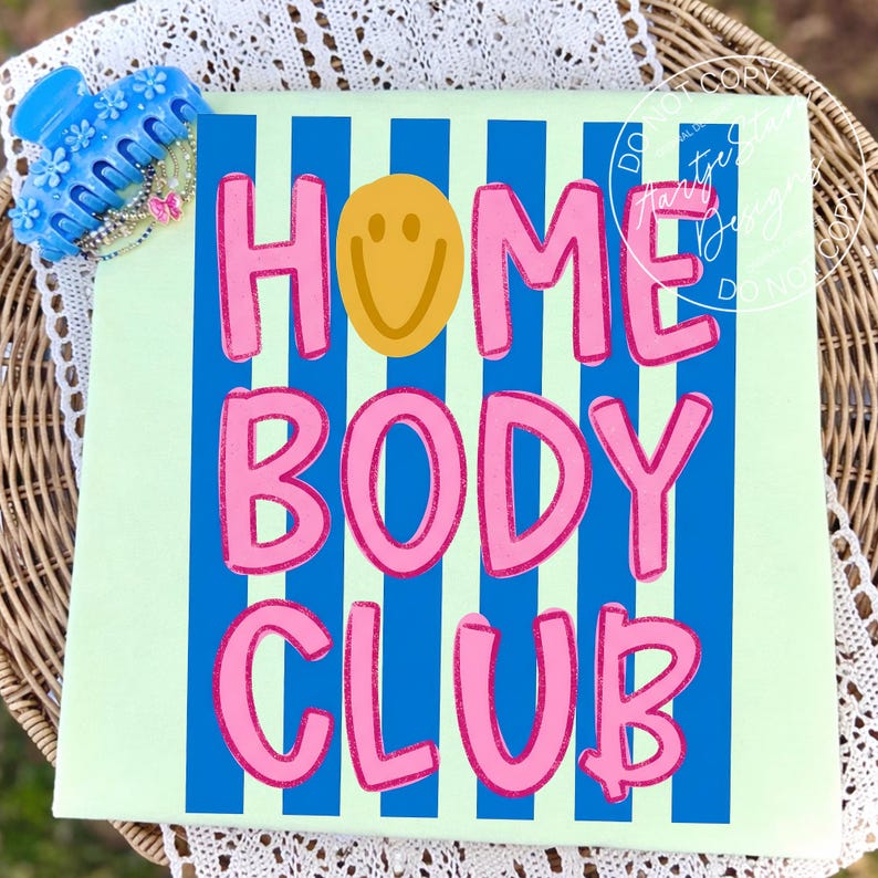 Homebody Club shirt PNG retro Y2K bold bubble letter smiley face blue stripe pink text, on mint green tee flatlay blue claw clip styling, coquette aesthetic teacher squad soft girl sassy funny saying shirt lazy girl era procrastination humor, for DTF transfers, sublimation shirts, tumblers, apparel printing.