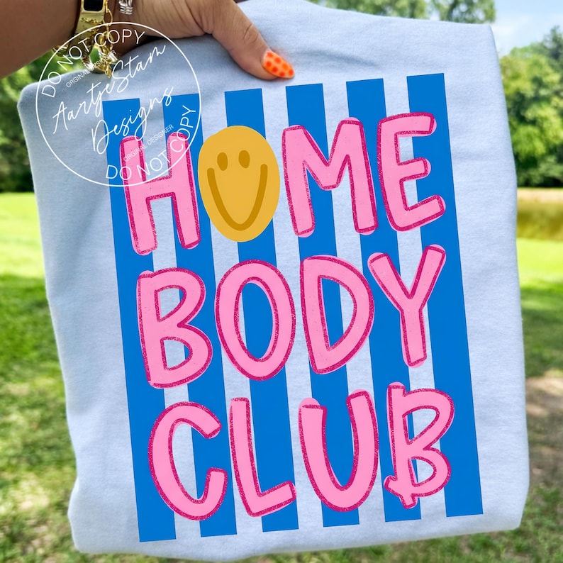 Homebody Club shirt PNG retro Y2K bubble letter smiley face blue stripe hot pink bold text, on ash gray tee held outdoor, lazy girl era couch potato sarcastic funny saying shirt VSCO girl soft girl homebody procrastination humor, for DTF transfers, sublimation shirts, tumblers, apparel printing.