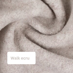 May include: Close-up of a soft, light beige fabric with a slightly textured surface. The fabric is folded and draped, creating a soft, flowing look. The text "Walk ecru" is visible in the lower left corner of the image.