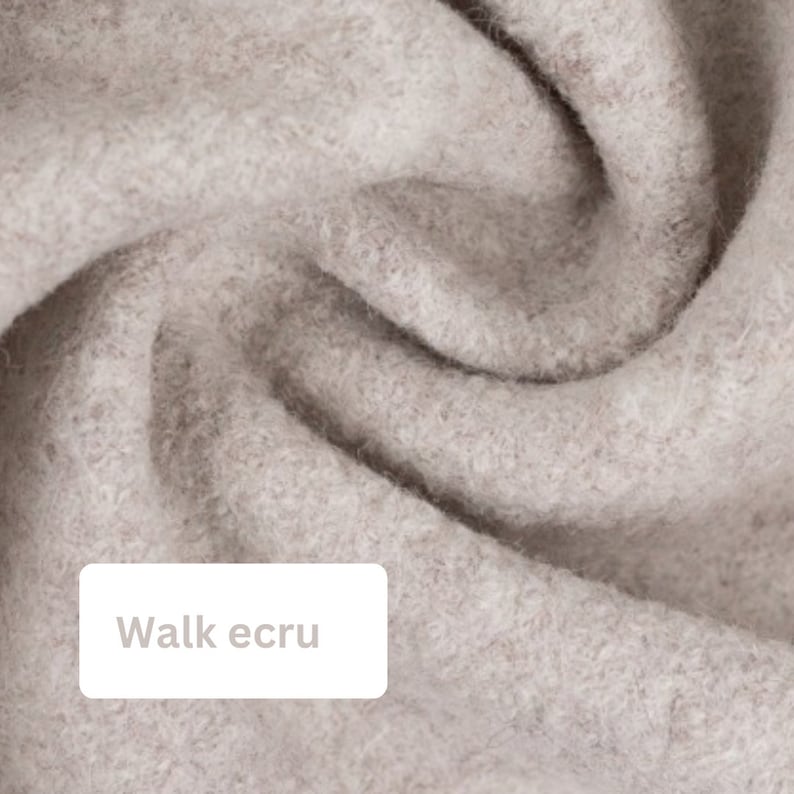 May include: Close-up of a soft, light beige fabric with a slightly textured surface. The fabric is folded and draped, creating a soft, flowing look. The text "Walk ecru" is visible in the lower left corner of the image.