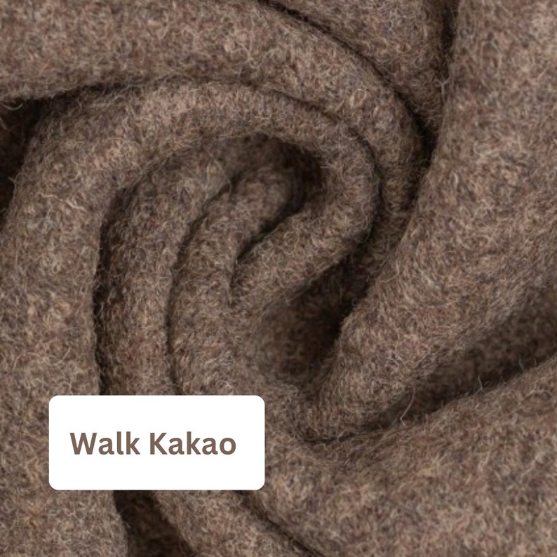 May include: Close-up of a brown felt fabric with the text "Walk Kakao" on a white label.