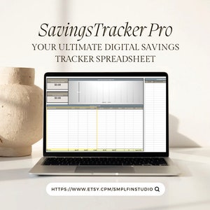 May include: A laptop computer displaying a digital savings tracker spreadsheet with the title "SavingsTracker Pro: Your Ultimate Digital Savings Tracker Spreadsheet". The spreadsheet has a graph and a table with columns for date, income, expenses, and balance. The website address "HTTPS://WWW.ETSY.CPM/SMPLFINSTUDIO Q" is displayed at the bottom of the screen.