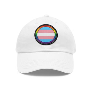 May include: White baseball cap with a rainbow-coloured circle patch featuring the transgender pride flag.