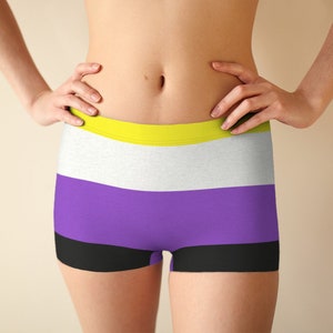 May include: A pair of black, purple, white, and yellow striped boxer shorts.