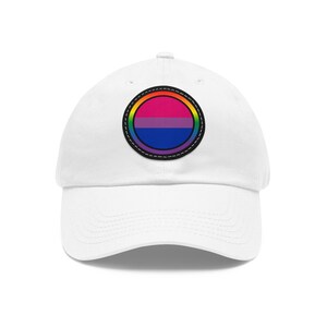 May include: White baseball cap with a circular patch featuring a bisexual pride flag with a rainbow border.