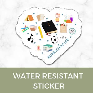 May include: Water resistant sticker with a heart shape and a variety of images related to homeschooling, including a book, a soccer ball, a tent, a ruler, a clock, a music note, a sewing needle, and a stack of books. The text "HOMESCHOOLER" is written in a white circle on the sticker.