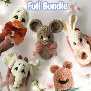 May include: A collection of handmade crochet baby rattles in the shape of animals, including a duck, mouse, and bunny. Each rattle features a soft, textured design with a ribbon bow. The text "Bitty Rattles Full Bundle" is displayed at the top.