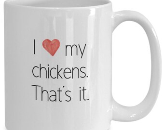 May include: White ceramic coffee mug with black text that reads "I love my chickens. That's it." A red heart is between the words "I" and "love".