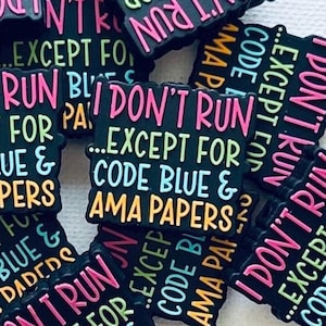 May include: A pile of black and colorful square stickers with the text "I don't run...except for code blue & AMA papers" repeated on each sticker.