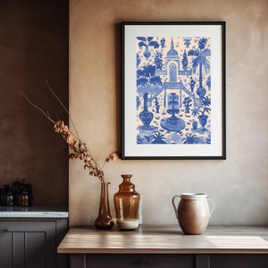May include: A framed print of a blue and white illustration of a garden scene with a fountain and a building. The illustration is on a cream background.