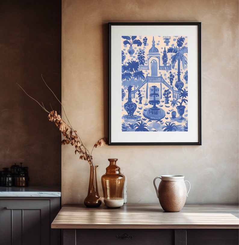 May include: A framed print of a blue and white illustration of a garden scene with a fountain and a building. The illustration is on a cream background.