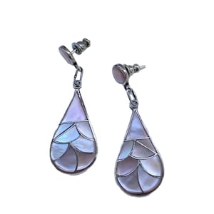 May include: Silver-tone drop earrings with a pearlescent, iridescent design. The earrings have a teardrop shape with a mosaic pattern of light pink, white, and lavender segments. The posts and chain links are silver.
