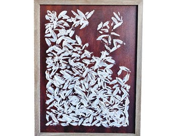 May include: Abstract painting with a brown background and white leaf-like brushstrokes. The artwork is framed in a light brown wooden frame, creating a modern and textured aesthetic. The white strokes are thick and textured.