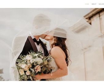 May include: A bride and groom kiss under a white veil, the bride holds a bouquet of white and pink flowers.
