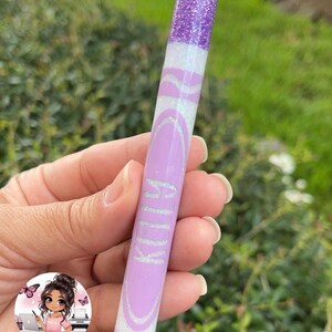 May include: Purple and white glitter pen with a black tip and the word "KILLA" written in white on the side.