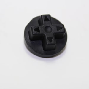 May include: A black rubber directional pad with four arrows pointing up, down, left, and right. The pad is circular and has a raised center.