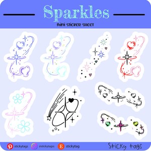 Op de afbeelding: Een mini-stickervel met diverse sparkle-ontwerpen. De stickers bevatten harten, sterren en vallende sterren in kleuren als roze, blauw en zwart. De tekst "Sparkles" en "Sticky tags" is ook zichtbaar.