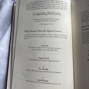 May include: Open book with text in Arabic and English. The page displays the title "Kashmir Maryam" and discusses the Quran's themes: Tawheed, Prophethood, The Afterlife, and Legal Rulings. The text "the different themes Allah (swt) talks about in the Quran" is at the bottom.