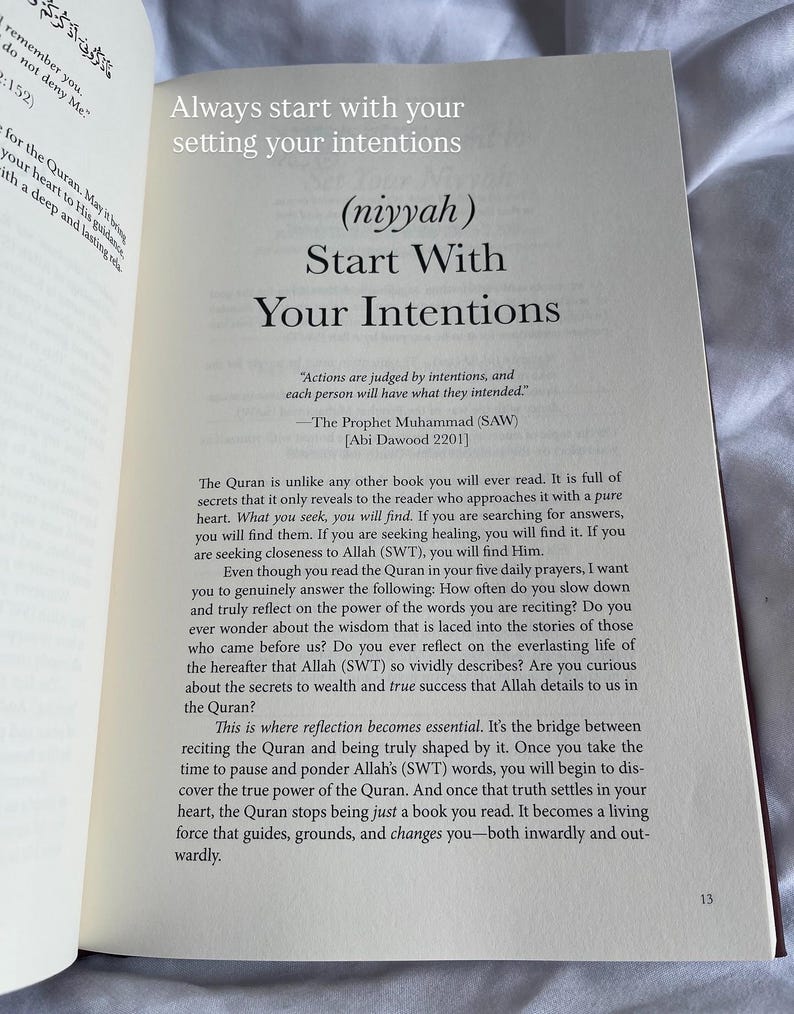 May include: Open book with text: "Always start with your setting your intentions" and "Start With Your Intentions." The text is in black on a cream-colored page. The book is open on a white surface.