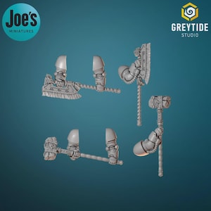 May include: A collection of miniature fantasy weapons, including axes and hammers, in a light gray color. The image features the logos "Joe's Miniatures" and "Greytide Studio". The weapons are designed with intricate details, suggesting a focus on tabletop gaming or model building.