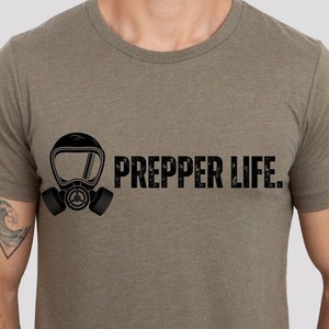 May include: A green t-shirt with a black gas mask graphic and the text "PREPPER LIFE."