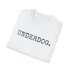 May include: White t-shirt with the word "UNDERDOG." printed in black.