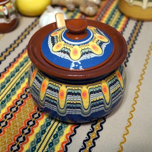 Ceramic sugar bowl with a wooden spoon, handmade and painted with a blue shade.