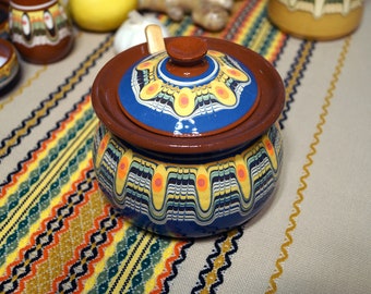 Ceramic sugar bowl with a wooden spoon, handmade and painted with a blue shade.