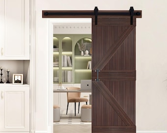 May include: A dark brown wooden barn door with a diagonal design, mounted on a black metal track. The door is partially open, revealing a glimpse of a home office with a desk, chair, and bookshelves. The door has a black handle.