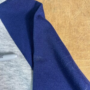 May include: A set of three ceramic mugs with a speckled, matte finish. The mugs are in shades of cream, light gray, and dark gray. Each mug has a simple, minimalist design, perfect for coffee or tea.