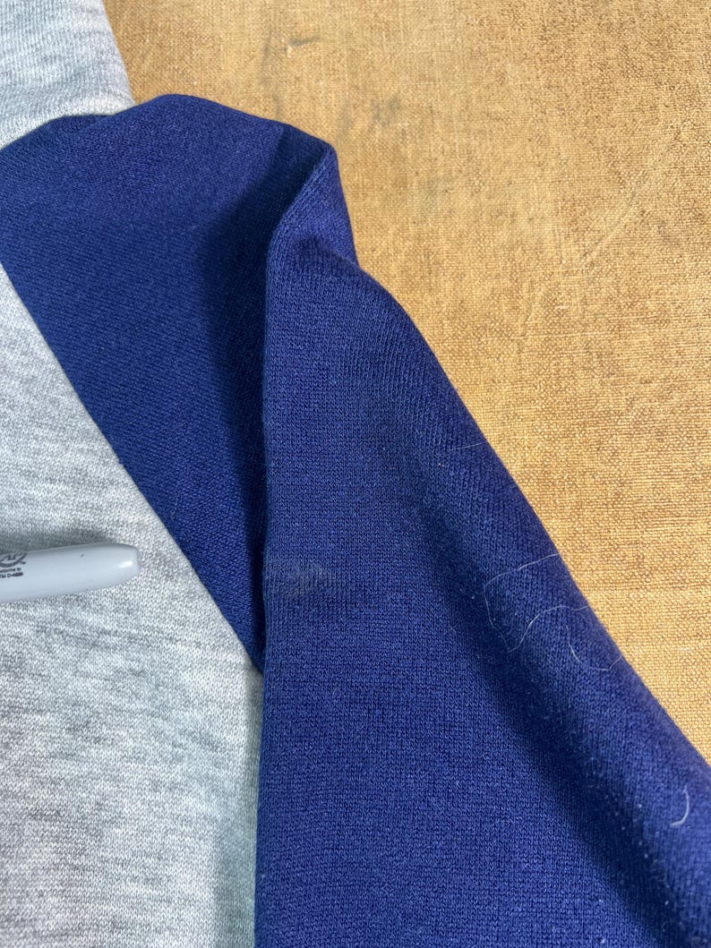 May include: A set of three ceramic mugs with a speckled, matte finish. The mugs are in shades of cream, light gray, and dark gray. Each mug has a simple, minimalist design, perfect for coffee or tea.