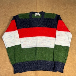 Peut inclure: Un pull à col en V multicolore avec des rayures horizontales rouges, blanches, vertes et bleu marine. L'étiquette indique "ADAM SLOANE". Les manches et l'ourlet inférieur sont bleu marine.