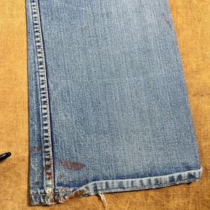 May include: A handmade, wooden cutting board with a natural wood grain finish. The board is rectangular with rounded corners and a juice groove. It measures approximately 18 inches long, 12 inches wide, and 1 inch thick.