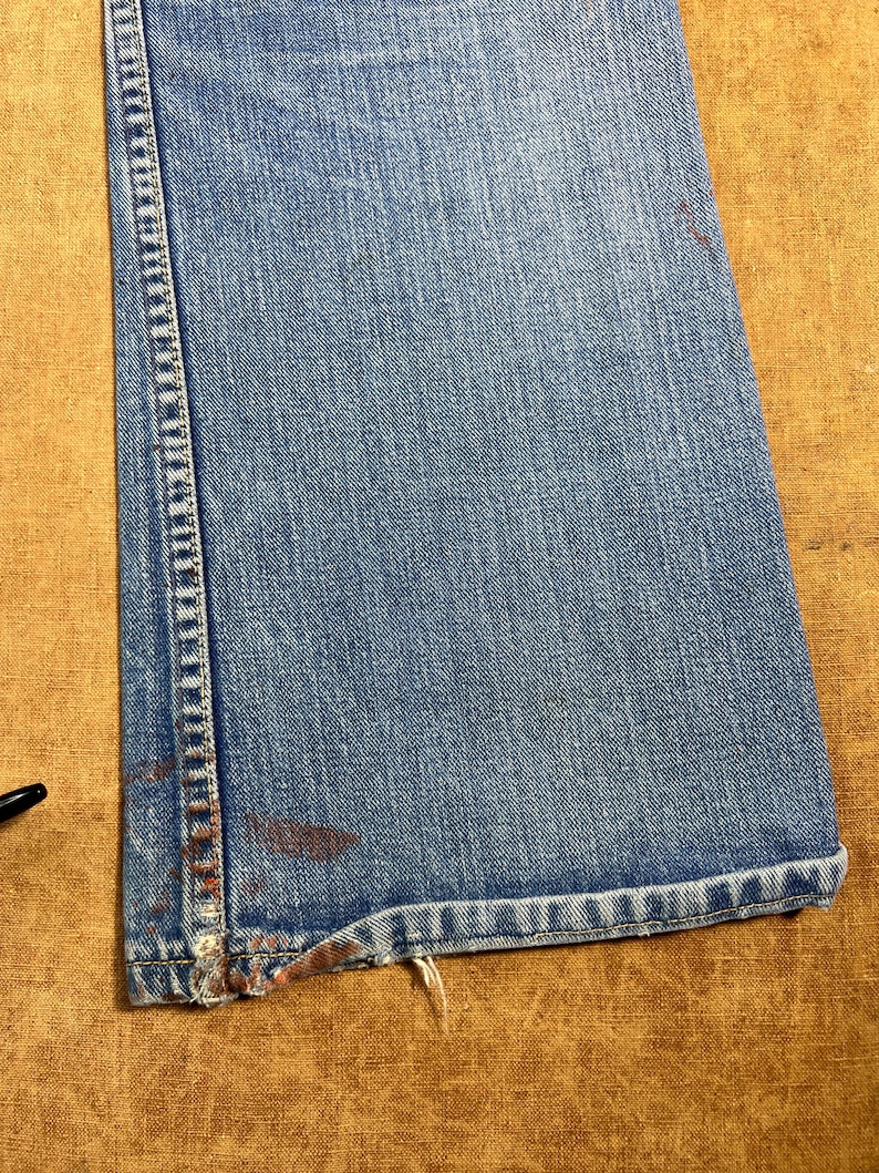 May include: A handmade, wooden cutting board with a natural wood grain finish. The board is rectangular with rounded corners and a juice groove. It measures approximately 18 inches long, 12 inches wide, and 1 inch thick.