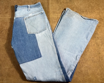 May include: Light and medium blue denim jeans with a patchwork design. The jeans have a classic five-pocket design and a wide leg. The denim has a faded, worn look.