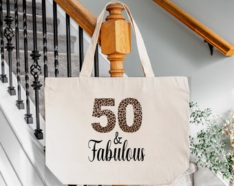 May include: A natural canvas tote bag with a leopard print 50 and the text "& Fabulous" in black.