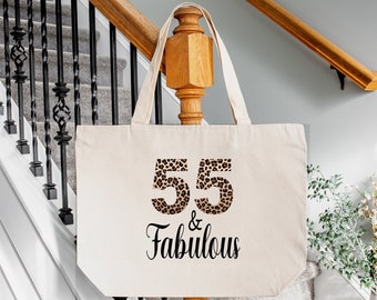 May include: A natural canvas tote bag with a leopard print design featuring the text "55 & Fabulous".