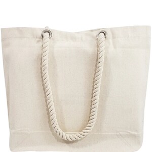 May include: A cream-colored tote bag with a rectangular shape. The bag features a thick, twisted rope handle attached with silver metal grommets. The bag is made of a sturdy canvas material, suitable for carrying various items.