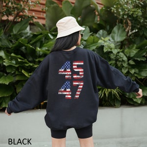 May include: Black sweatshirt with a distressed American flag design featuring the numbers 45 and 47 on the back.