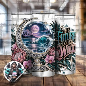 May include: A cylindrical tumbler featuring a graphic of a crystal ball containing a moonlit ocean scene with a large wave, framed by ornate silver metalwork, pink protea flowers, and orchids. The text reads THE FUTURE LOOKS WILD.
