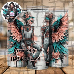 May include: A tumbler with a design of a woman with angel wings, tattoos, and sunglasses. The design includes teal and peach wings, floral accents, and the text "Error 404: Halo Not Found." A smaller image shows a woman with a skull.