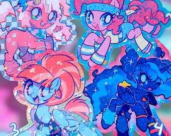 May include: Four colorful pony stickers with glitter accents. The stickers feature cartoon ponies in shades of pink, blue, and purple. Each pony has a unique design, with numbers 1 through 4 visible on the stickers.
