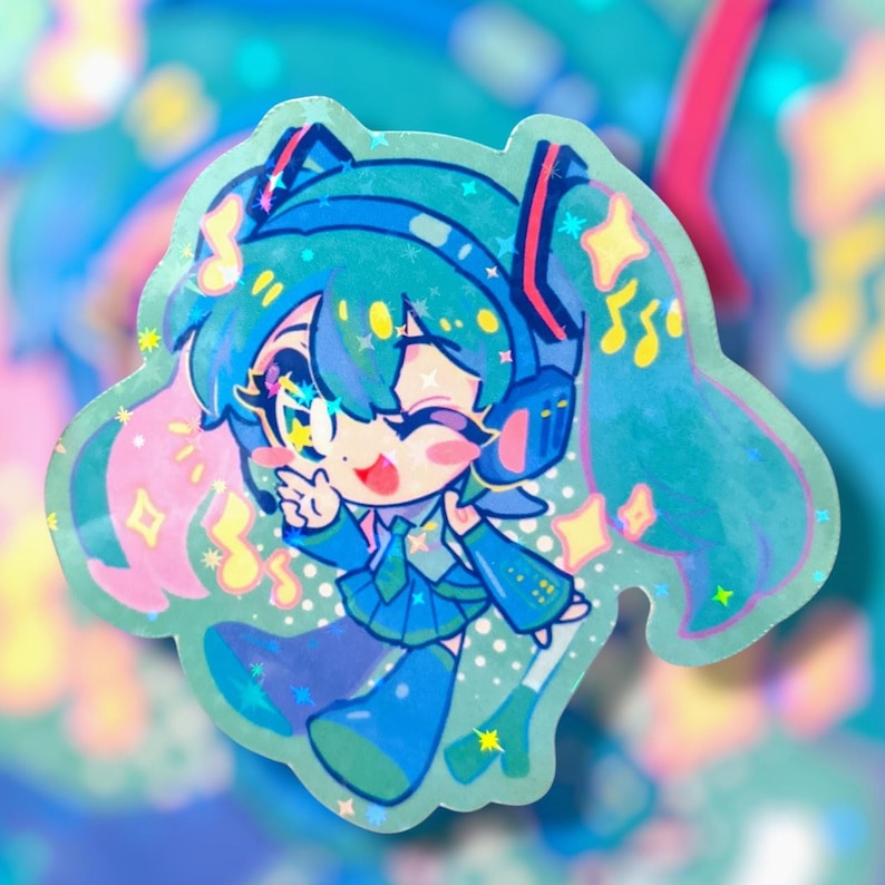 May include: A holographic sticker featuring a cartoon character with teal hair, headphones, and a blue outfit. The character is winking and giving a peace sign, surrounded by stars and musical notes. The sticker has a shiny, iridescent finish.