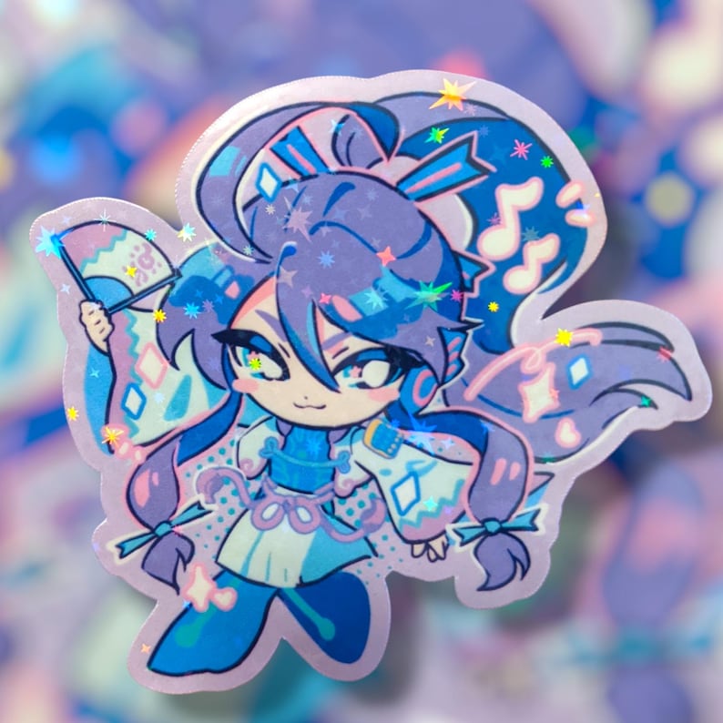 May include: A holographic sticker featuring a cartoon character with blue and purple hair and clothing. The character is holding a fan and has musical notes and star accents. The sticker has a shiny, iridescent finish.