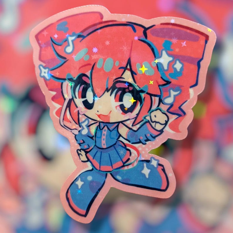 May include: A holographic sticker featuring a cartoon character with pink hair and a blue outfit. The character has large eyes and is surrounded by musical notes and stars. The sticker has a pink border.
