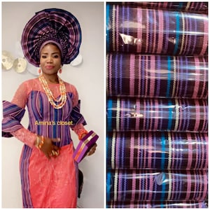 May include: A woman wearing a colorful striped dress and a large purple head wrap. She is holding a purple and gold clutch. The fabric is shown in a separate image, with a close-up of the striped pattern.