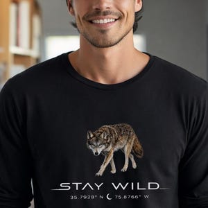 May include: A white ceramic mug with a black handle and the text "But First, Coffee" in a bold, black font. The mug is set against a neutral background, highlighting its simple design.