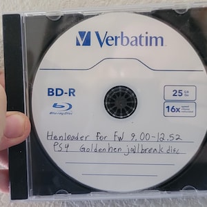 May include: A Verbatim BD-R Blu-ray disc in a clear plastic jewel case. The white disc label features the Verbatim logo, 25GB capacity, and 16x speed. Handwritten text on the disc reads: Henloader for Fw 9.00-12.52 PS4 Goldenhen jailbreak disc.